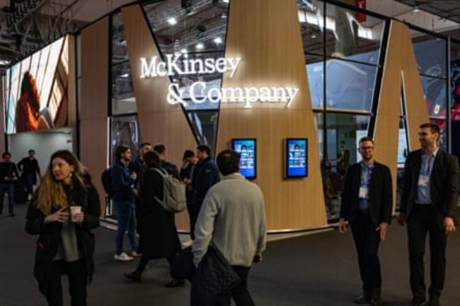 people standing in a room un a McKinsey sign.