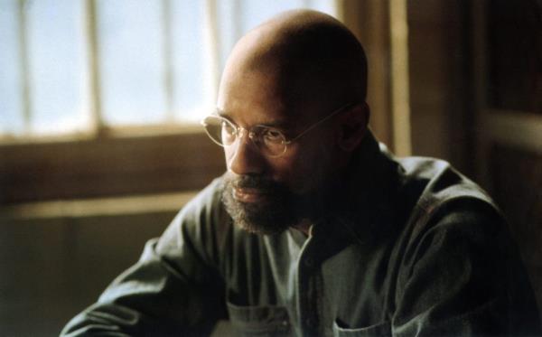 Denzel Washington in the 1999 film, 'The Hurricane', wearing glasses and a green shirt