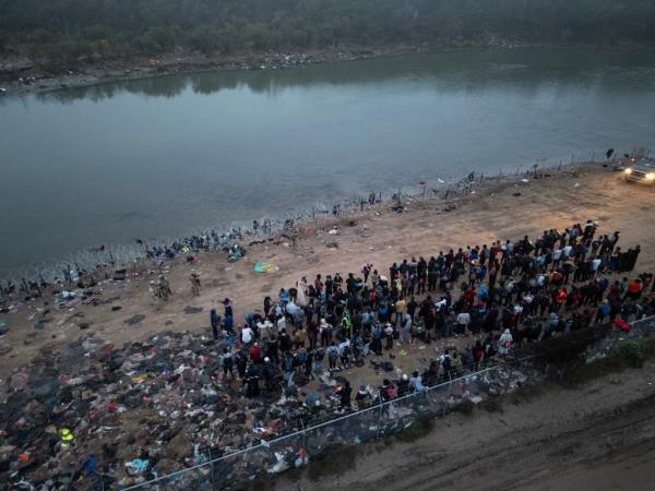 Migrants, mostly from Venezuela are rounded up by US authorities after crossing the Rio Grande into the US from Mexico in Eagle Pass, Texas on Dec. 23, 2023.