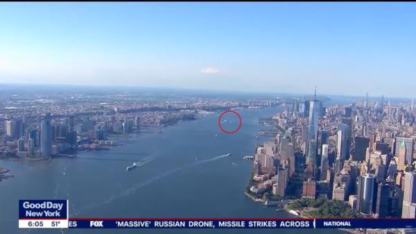 Brilliant orb-like object caught on news camera zooming over Lower Manhattan.