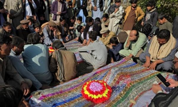 Mourners pray at the burial of the victims of Thursday’s attack.