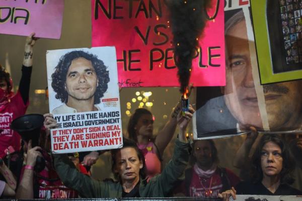 A demo<em></em>nstrator during an antigovernment protest in front of the Defence Ministry in Tel Aviv